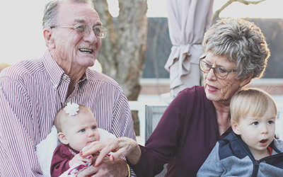Seniors holding grandchildren